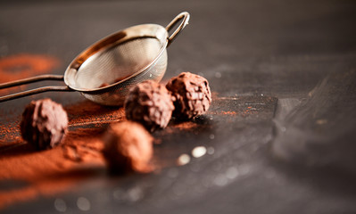 Chocolate bonbons sprinkled with cocoa powder