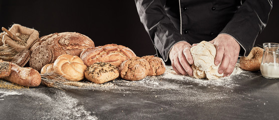 Baker kneading dough to make gourmet bread