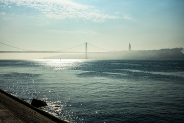 It is the longest bridge in Europe over the Tagus river. Morning, fog. Copy space.