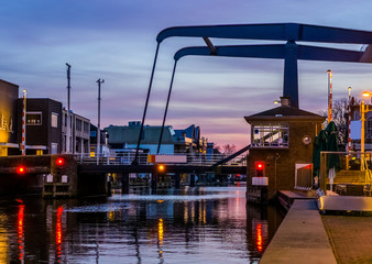 the popular city bridge alphensebrug in Alphen aan den Rijn, the Netherlands, beautiful water scenery at sunset
