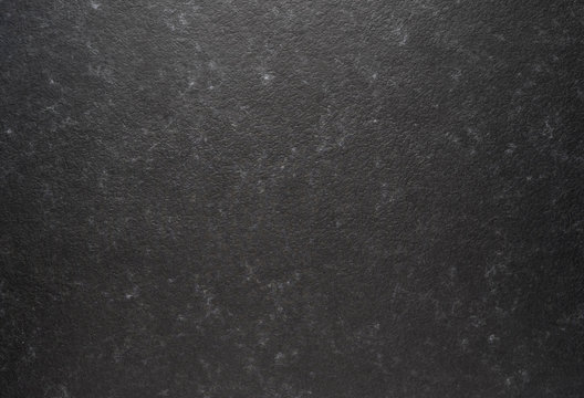 Black and grey cardboard textured background, empty and blank surface for text or design, flat lay, top view