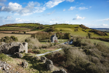 Landscape view from the Rock of Dunamase ruins in county Laois with small church and hills in the background. Blue sky with clouds. Ireland   