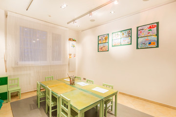 Kindergarten tables with painting brush. Preschool class waiting kids.