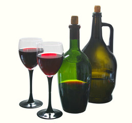 Two glasses of red wine and two bottles on white. Isolated on white