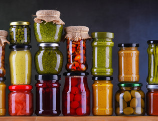 Jars with variety of pickled vegetables and fruits
