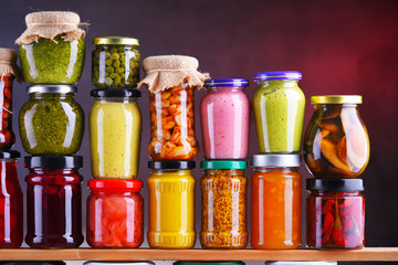 Jars with variety of pickled vegetables and fruits