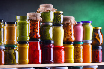 Jars with variety of pickled vegetables and fruits