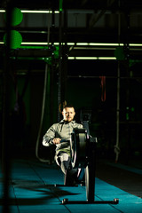 Fototapeta na wymiar Workout on the rowing machines at the gym