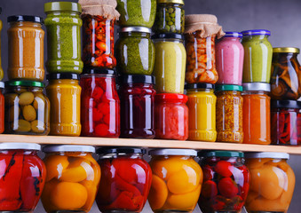 Jars with variety of pickled vegetables and fruits