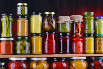 Jars with variety of pickled vegetables and fruits