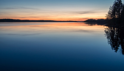 Obraz premium Scenic dawn landscape with lake after sunset at spring evening in Finland