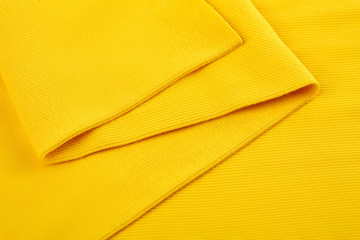 Yellow cotton textile - close up of fabric texture. Cotton Fabric Texture. Top View of Cloth Textile Surface. Yellow Clothing Background. Text Space. Abstract background and texture for designers.