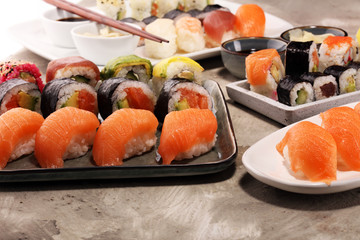 close up of sashimi sushi set with chopsticks and soy - sushi roll with salmon and sushi roll with smoked eel