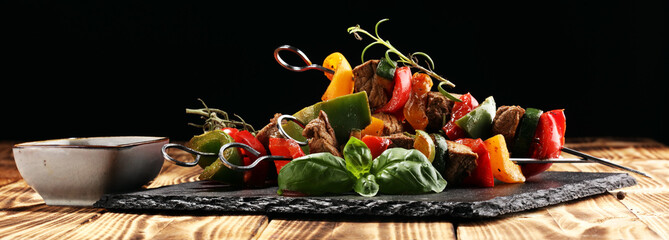 Grilled pork shish or kebab on skewers with vegetables . Food background shashlik