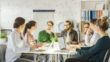 Personable Woman Speaks Up on a Strategic Planning Session. Her Coworkers Listen Attentively. They...