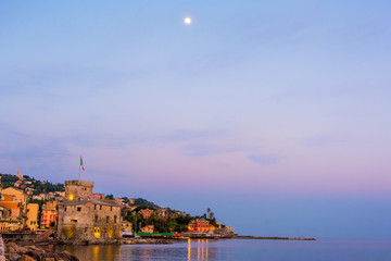 panorama italian sea village space text and moon high in the sky - Rapallo italy sea town copy space background night sunset
