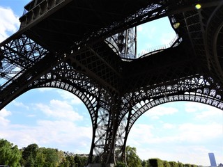 Elements of the Eiffel tower in Paris against a blue clear sky