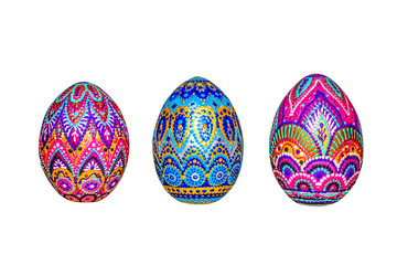 Wooden Easter eggs, painted in patterns by hand with acrylic paints, isolated on a white background.