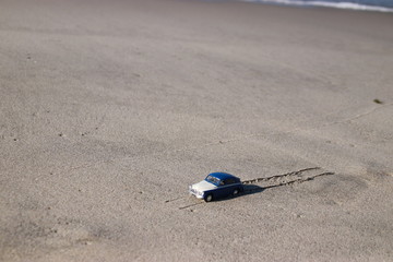 Fototapeta na wymiar Toy car on the coast.