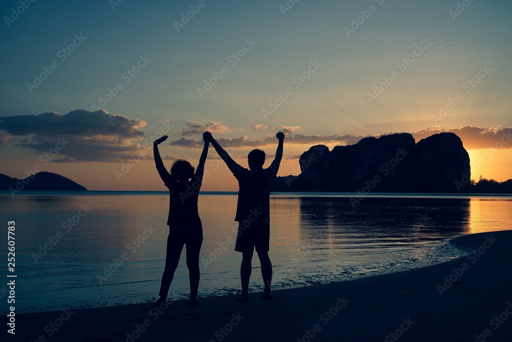 Poster couple on the beach at sunset