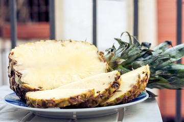 Fresh ripe pineapple on plate, vegetarian concept