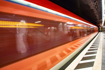 blurred motion of metro train entering the train station