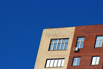 Modern brick office building on a background of clear blue sky.