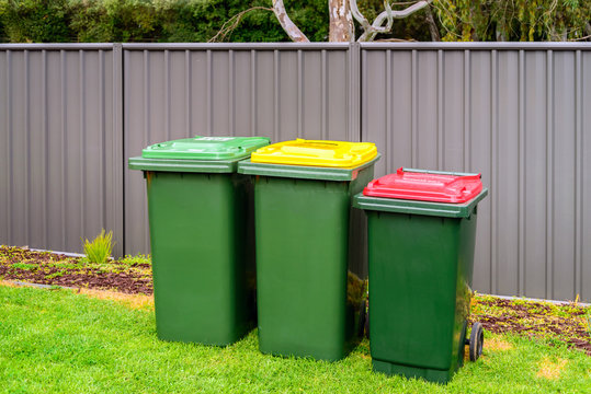 Australian home rubbish bins set on back yard