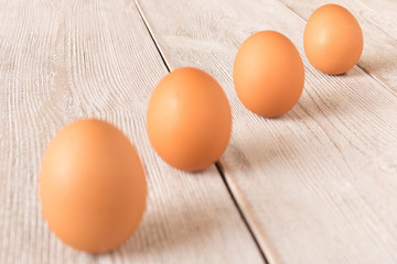 Chicken eggs on a wooden table. Selective focus.