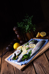 fresh trout with lemon and different herbs