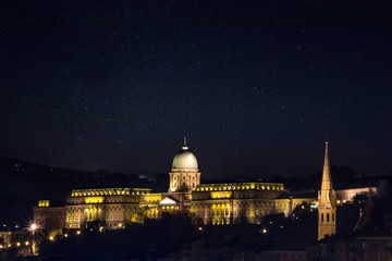 Obraz premium Night photo of the Buda Castle, Budapest, Hungary in sunny day with blue sky background