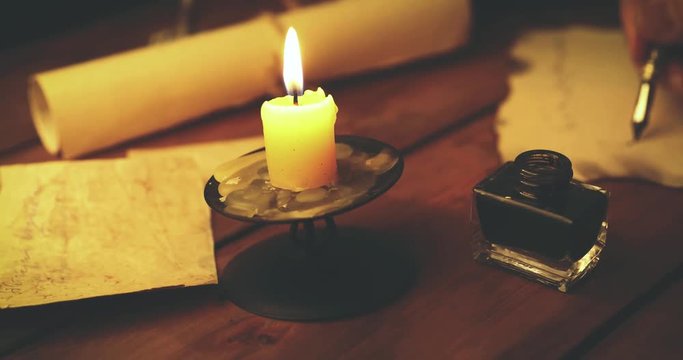 handwriting calligraphy - writing letter with quill pen and ink in candlelight