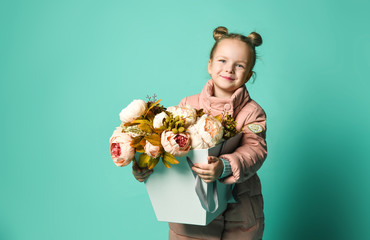 Girl holding peonies bouquet on blue background