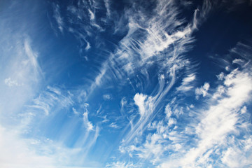 Blue sky with tattered clouds