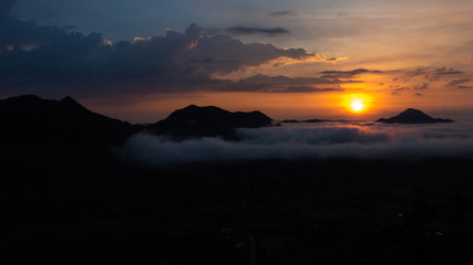 Beautiful dramatic sunset in the mountains. Landscape lot of fog Phu Thok Mountain at Chiang Khan ,Loei Province in Thailand.