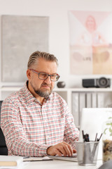 Casual looking handsome corporate manager at his office