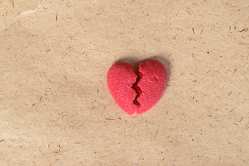 Fototapeta premium Broken candy heart on paper