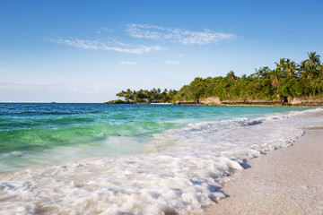an exotic white beach with blue and turquoise water and white sand in a tranquil relaxing scene
