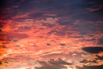 Naklejka na ściany i meble Sunset sky background with fiery clouds, orange and blue colors.