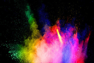 Multicolored powder explosion on white background.Abstract colorful dust particles textured...