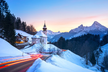 Beautiful winter wonderland mountain scenery in the Alps with pilgrimage church of Maria Gern and...