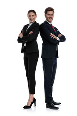 couple in business suits standing back to back