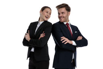 couple in business suits standing back to back