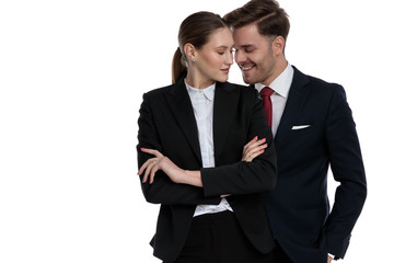 couple in business suits standing together smiling