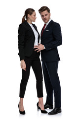 couple in business suits holding hand on waist