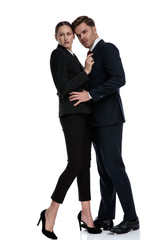 couple in business suits holding hands on each other