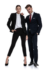 couple in business suits looking serious with attitude