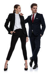 couple in business suits looking away