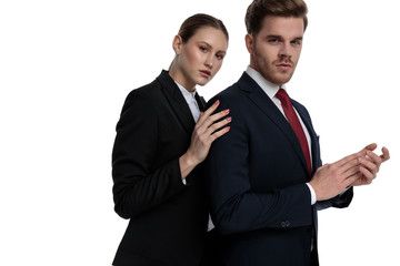 couple in business suits holding hands together