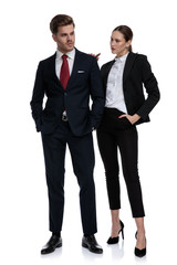 couple in business suits looking serious
